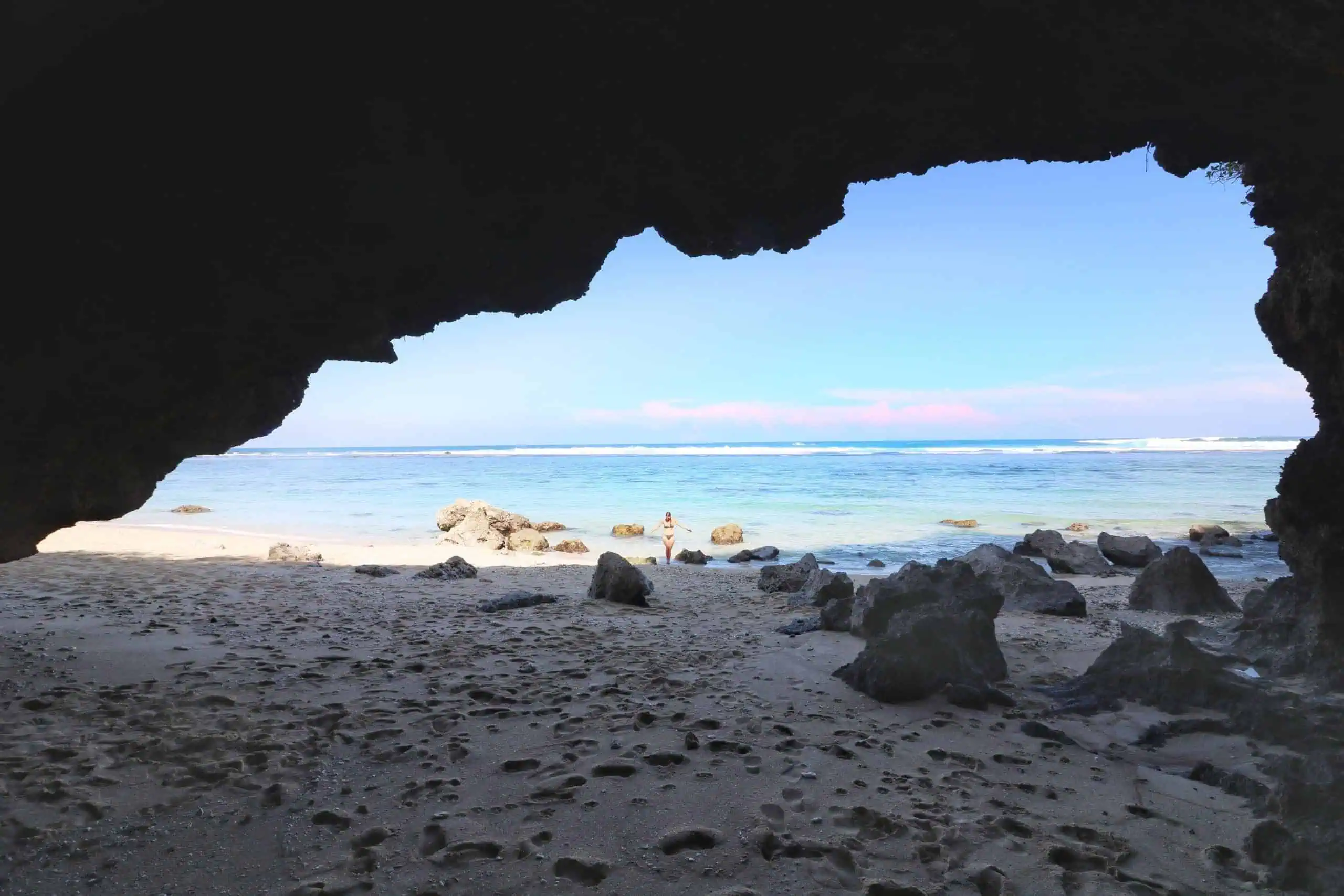 Nice and shady cave at Gunung Payung Cave with the blus sea and clear sky in the background